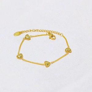 Elegant gold titanium heart bracelet with four charms and K18 hallmark detail