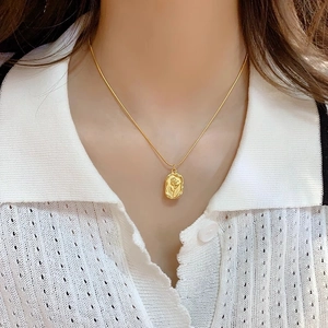 Vintage gold tulip flower relief pendant on a minimalist necklace for women