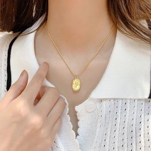Model wearing gold tulip flower relief pendant necklace with elegant snake chain design