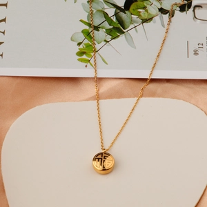 Golden titanium steel necklace featuring a hollowed Fu character pendant on a white stone