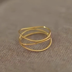 Minimalist three-layer intertwined gold titanium steel ring for women in a sleek design