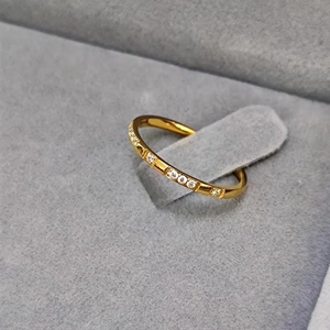 Detailed macro view of minimalist gold plated titanium ring with diamond inlay accents