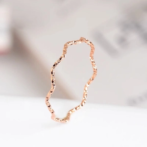Rose gold wavy ring with shimmering hammer texture finish for a minimalist modern look
