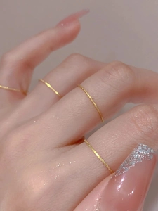 Close-up of minimalist gold-plated stacking rings with subtle frosted sand finish