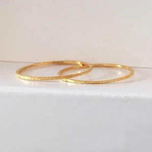 Set of two minimalist gold glitter sand thin stackable rings with a matte textured finish