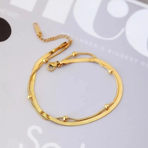 Double-layered gold titanium steel anklet featuring a flat snake chain and beaded link chain