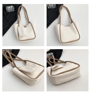 Close-up of minimalist white tote bag with removable mini pouch and sleek brown edge paint