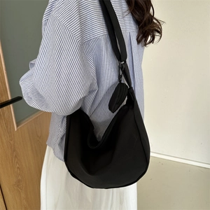Minimalist black nylon hobo crescent bag with wide strap and matching round coin purse