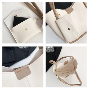Detail view of cream tote bag featuring magnetic closure and detachable inner pouch