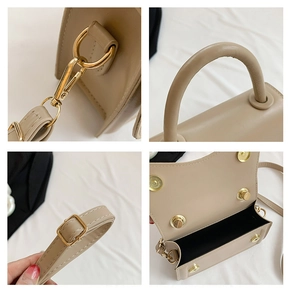 Detailed close-up of light beige crossbody bag hardware, handle, and adjustable shoulder strap