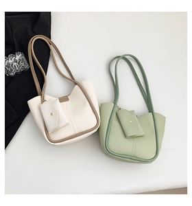 Minimalist tote bag detail showing sage green and cream faux leather with hanging coin pouch