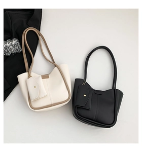 Minimalist bucket bag and pouch set featuring soft leather texture and long straps