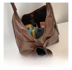 Detail view of large dark brown leather tote bag with ample space for daily essentials