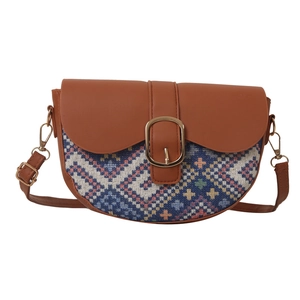 Ethnic style saddle bag with geometric weaving and brown leather strap on white background