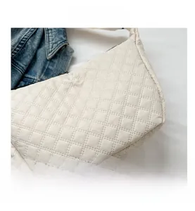 Macro shot of off-white nylon quilted pattern and premium stitching on shoulder bag