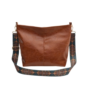 Brown vintage faux leather tote bag with colorful ethnic pattern woven shoulder strap