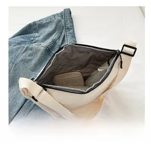 Interior view showing the large capacity of this cream quilted nylon crossbody bag