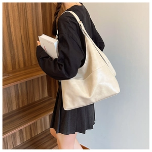 Minimalist beige faux leather tote bag for women showing large capacity and side pocket