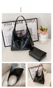 Macro shot of black pebbled leather Hobo bag with matching zipper pouch set