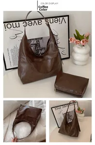 Detail of dark brown faux leather crescent tote with matching zipper pouch and texture
