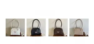 Detailed view of four butterfly embroidery shoulder bags in white black brown and khaki