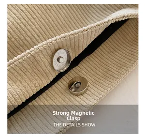 Detail of strong magnetic buckle on beige corduroy tote bag with black lining