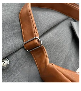 Detail of brown leather strap with adjustable silver metal buckle on a shoulder bag