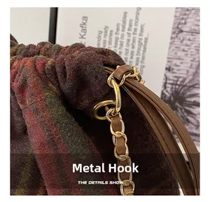 Macro shot of durable gold metal hardware and brown leather drawstring on woolen bag