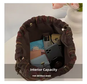 Detail view of large interior capacity for woolen bucket bag with chain strap