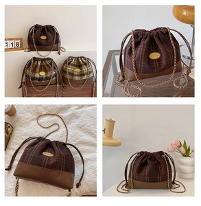 Detail of wool bucket bag with drawstring closure and golden logo plate