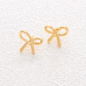 Elegant gold bow-knot stud earrings in stainless steel on a white textured background