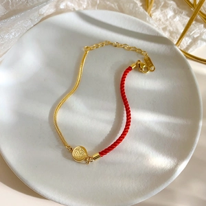 Titanium steel lucky red cord anklet with 18K gold plated Fu pendant on ceramic plate