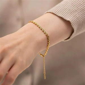 Elegant gold heart link chain bracelet for women with adjustable extender in a lifestyle view