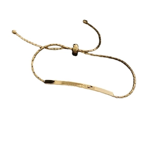 Detailed view of the adjustable gold titanium ankle bracelet with LOVER DREAM engraving