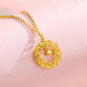 Exquisite golden dreamcatcher pendant necklace featuring a 3D woven hollow design on pink background