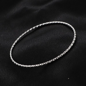Polished silver titanium steel star bangle with diamond-cut texture for women