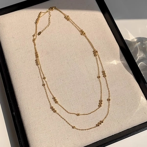 Elegant gold double layer beaded titanium steel necklace with a minimalist layered design