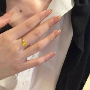 Elegant gold rose flower ring for women worn on finger showing fine relief details