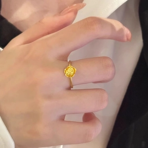 Elegant gold rose flower ring on model finger, minimalist stackable jewelry for women