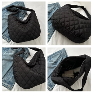 Macro detail of black quilted nylon hobo bag featuring diamond stitching and large capacity