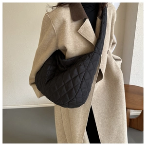 Quilted black nylon hobo tote bag with padded shoulder strap shown at a 45-degree angle