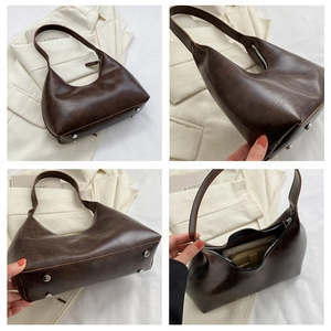 Detail view of retro brown PU leather hobo bag with metal rivets and spacious interior