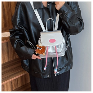 Silver mini backpack in mirrored faux leather with pink drawstrings and plush monster charm