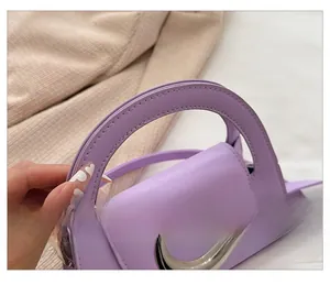 Detail view of light purple mini handbag with silver crescent buckle and matte finish