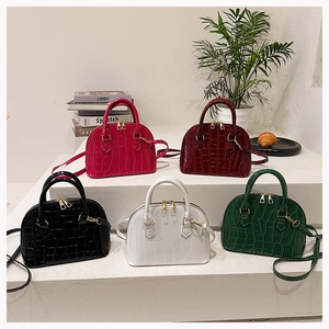 Elegant crocodile pattern shell bags in multiple colors displayed on white stairs