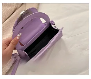 Detail show of lavender crescent handbag interior with magnetic buckle and strap