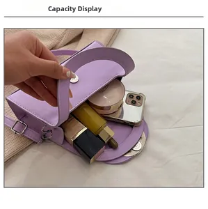Interior capacity show of purple leather handbag with phone and cosmetics