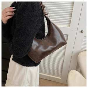 Detail view of a vintage dark brown hobo bag with Fashion & Bags embossed logo