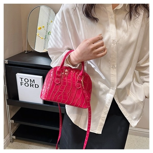 Crocodile pattern shell bag in bright pink with high gloss finish and gold hardware