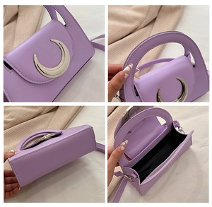 Detail of purple PU leather bag featuring a silver crescent metal buckle and inner lining